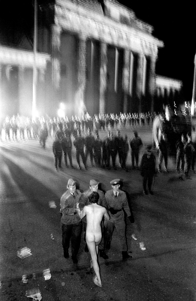 One of the defining moments of the 20th century, the fall of the Berlin Wall was a huge leap into the unknown for so many. It was cold the night of the 9th of November, and among the thousands upon thousands at the Brandenburg Gate this man chose to express his new-found freedom by removing all of his clothes and jumping down into East Berlin, an act that not long before would have resulted in him being shot. For me this image redefined my approach to photography. Image Credit © Simon Townsley