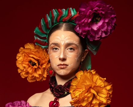 portrait of a woman with large flowers around her head