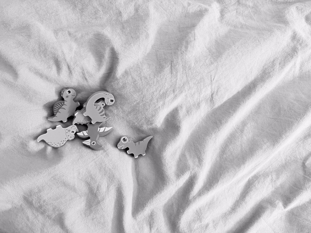 Some dinosaur shapes on a bed