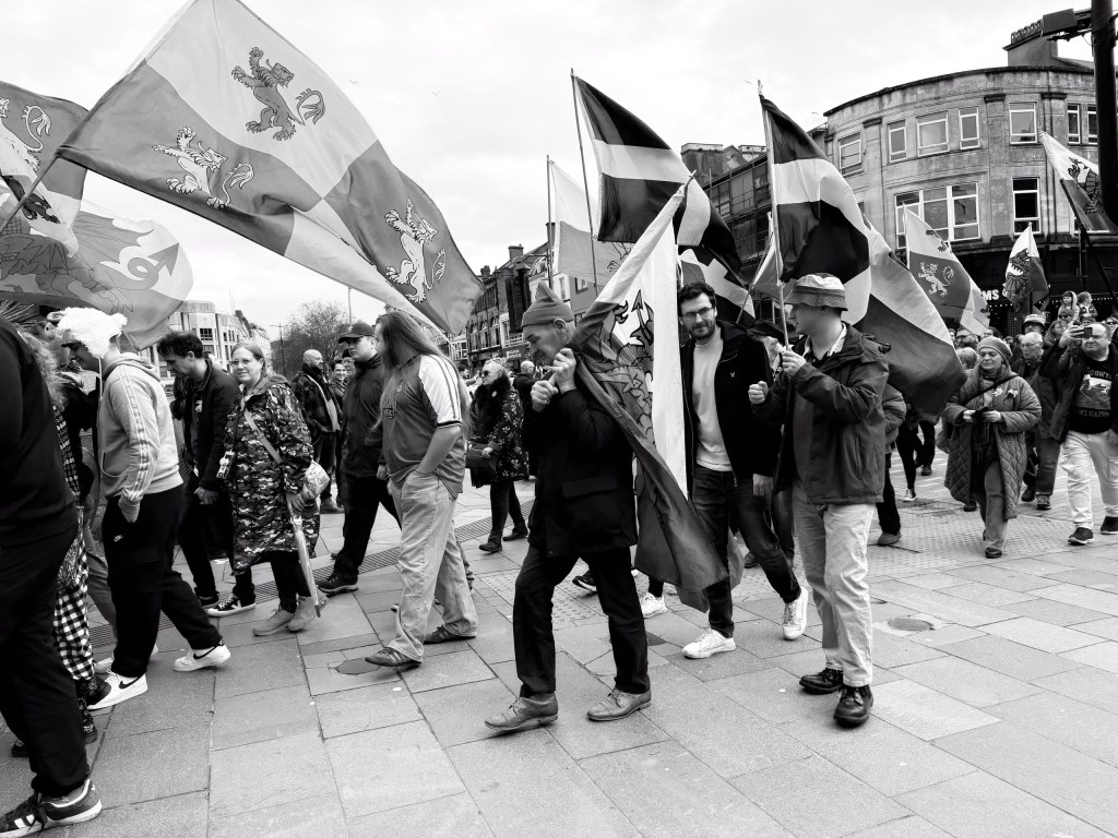 A parade or protest taking place in a city centre