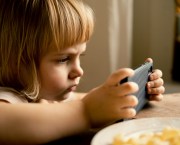 A toddler using a smartphone to take a picture