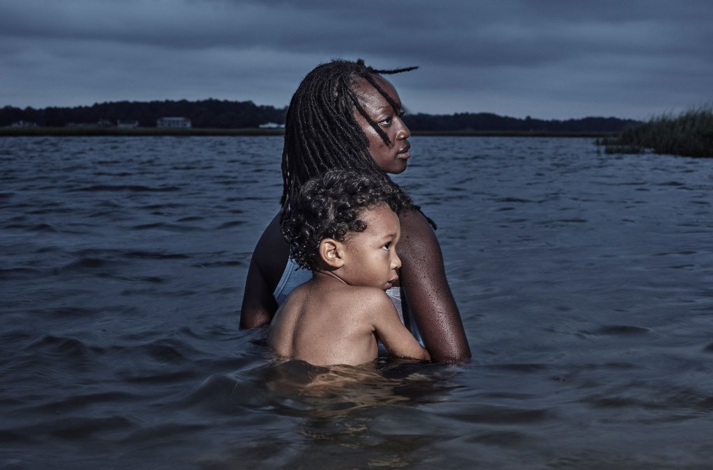 woman and baby half submerged in the sea